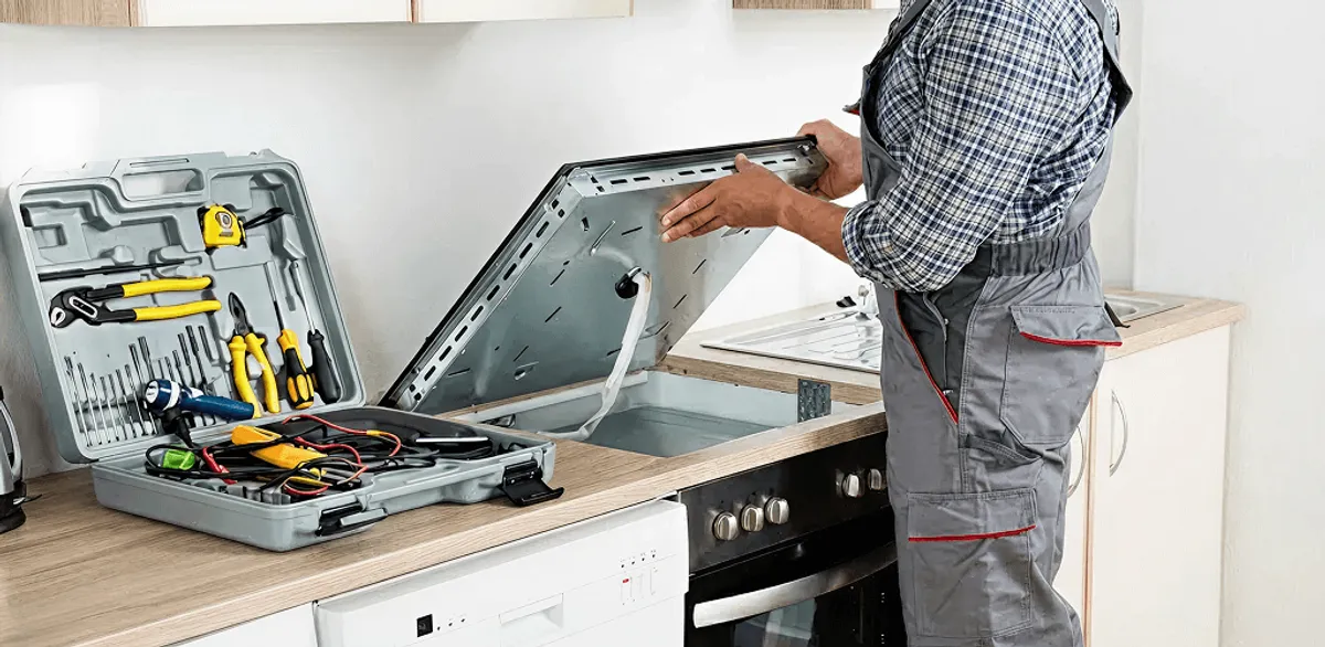 Handyman repairing a cooktop and checking wiring connections in San Jose, CA