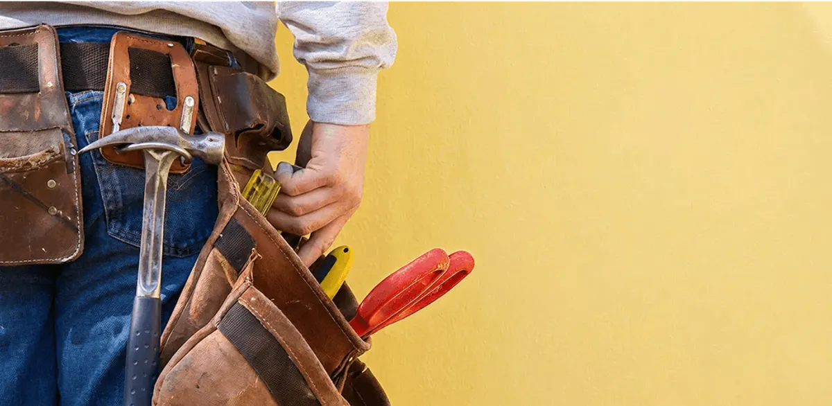 Handyman with tool belt ready for home repairs and maintenance in San Jose, CA