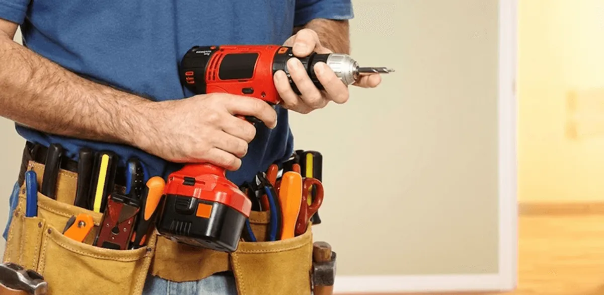 Handyman holding a power drill for home repairs and installations in San Jose, CA